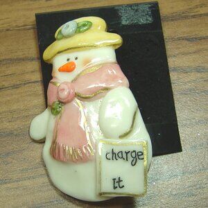 Vintage Nancy Williams glossy ceramic snowman pin--"Charge It"